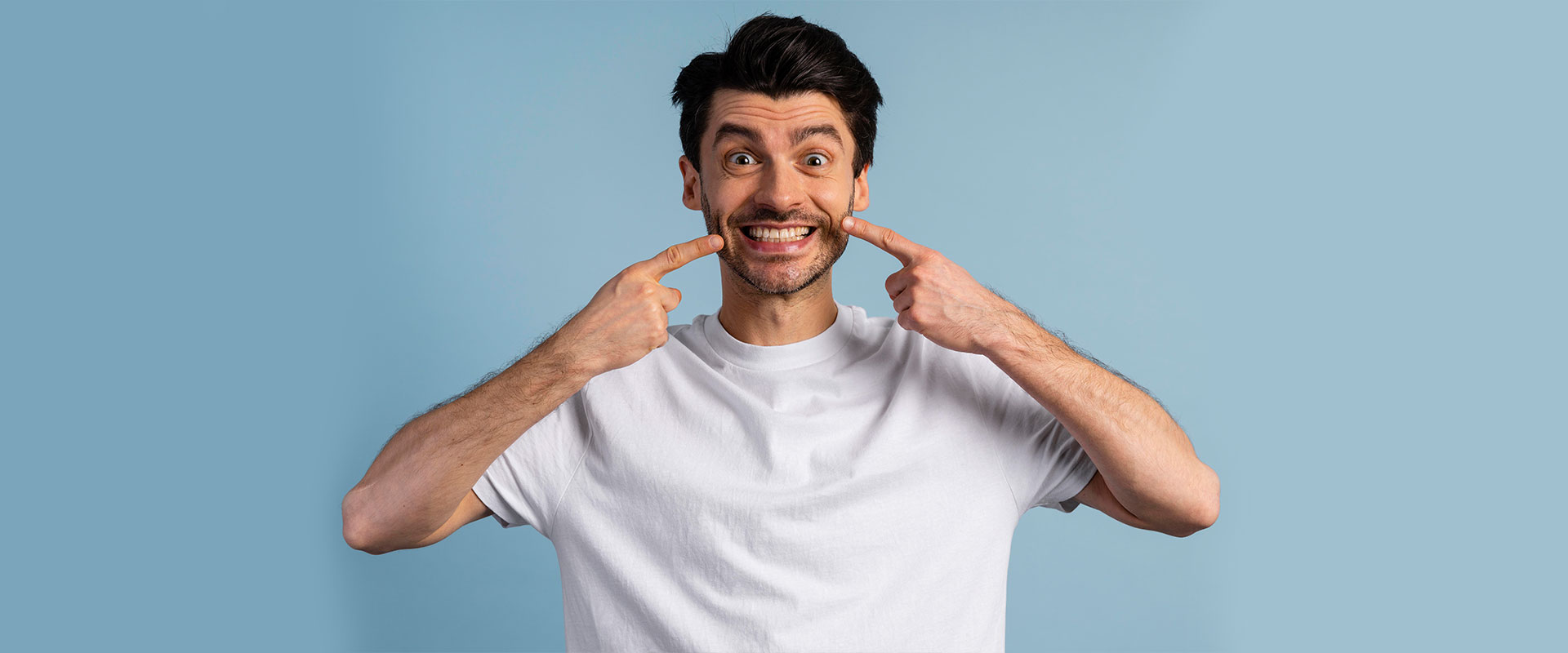 Boy indicate their teeth after gum grafting treatment